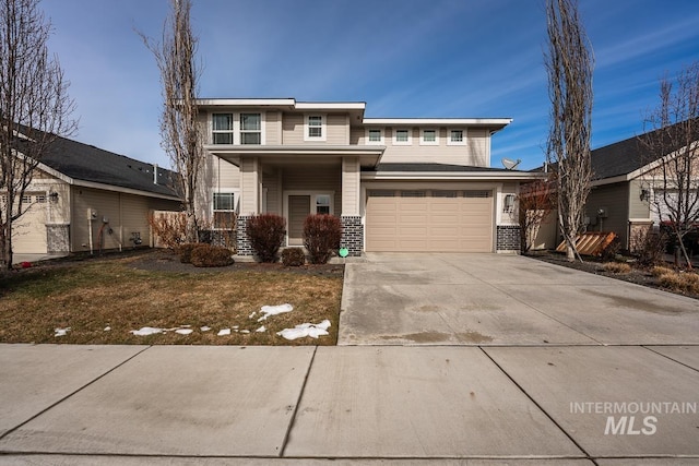 view of front of property with a front yard and a garage