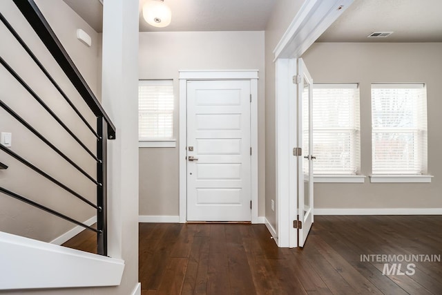 entryway with dark hardwood / wood-style floors