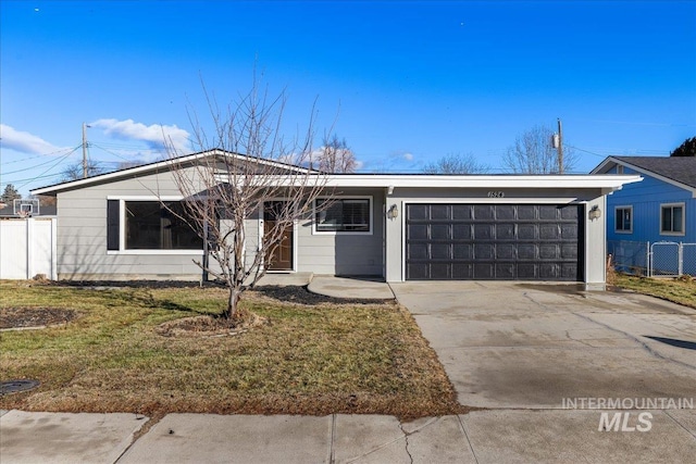 ranch-style home featuring a garage and a front lawn