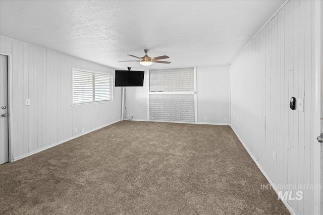 unfurnished room featuring ceiling fan, carpet flooring, and a textured ceiling