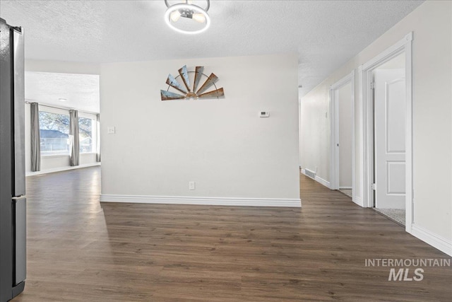 interior space featuring dark hardwood / wood-style floors and a textured ceiling