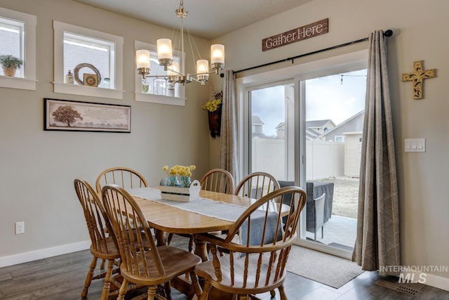 dining room with a chandelier, baseboards, and a wealth of natural light