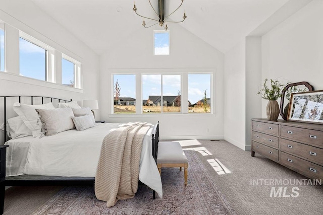 carpeted bedroom featuring a high ceiling and a notable chandelier