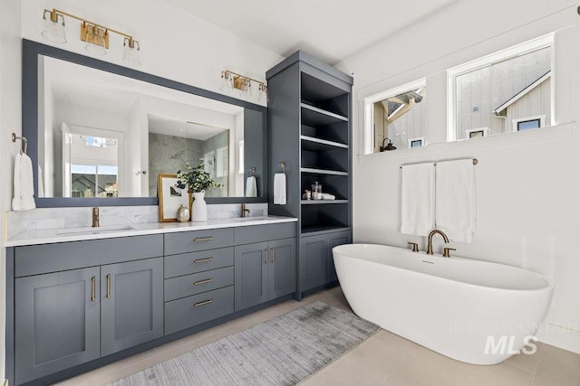 bathroom with tile patterned floors, vanity, and shower with separate bathtub