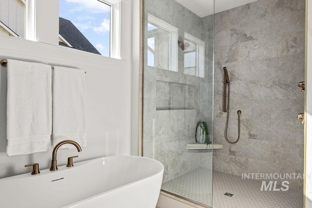 bathroom featuring sink and independent shower and bath