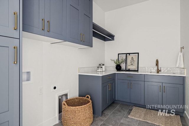 washroom with cabinets, electric dryer hookup, and sink