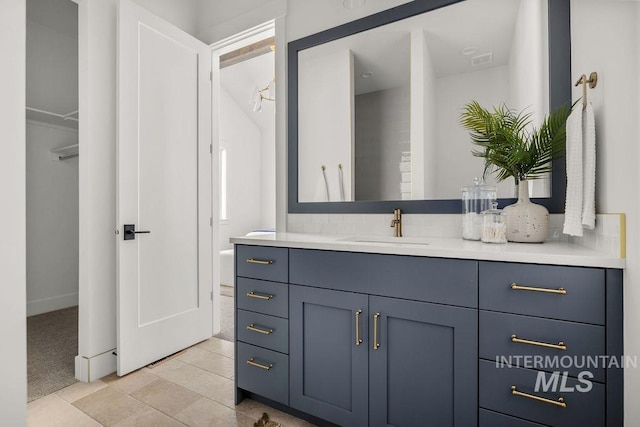 bathroom with tile patterned flooring and vanity