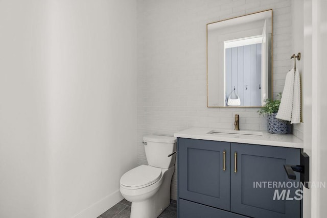 bathroom featuring tile patterned flooring, vanity, and toilet