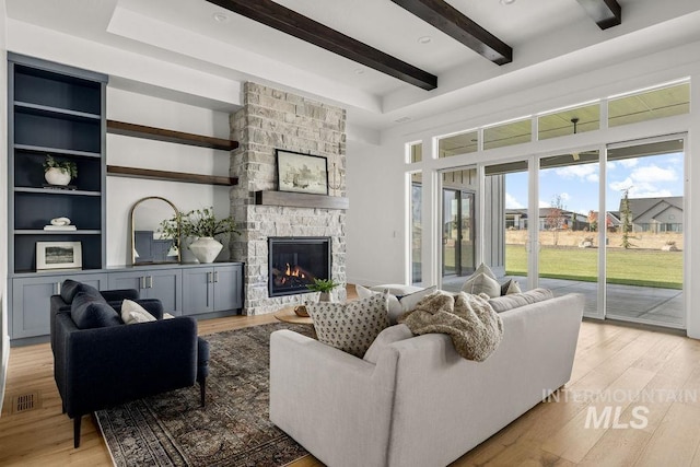 living room featuring a fireplace and light hardwood / wood-style floors