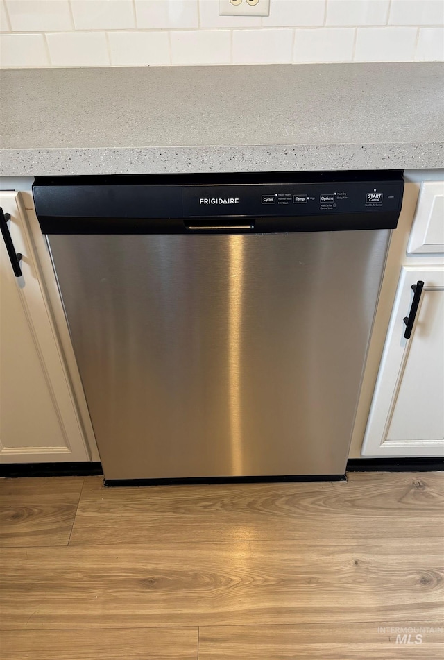 room details featuring white cabinetry and stainless steel dishwasher