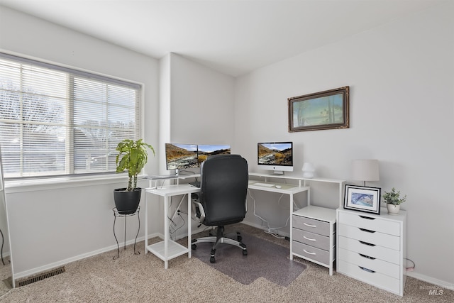 home office with a healthy amount of sunlight and carpet flooring