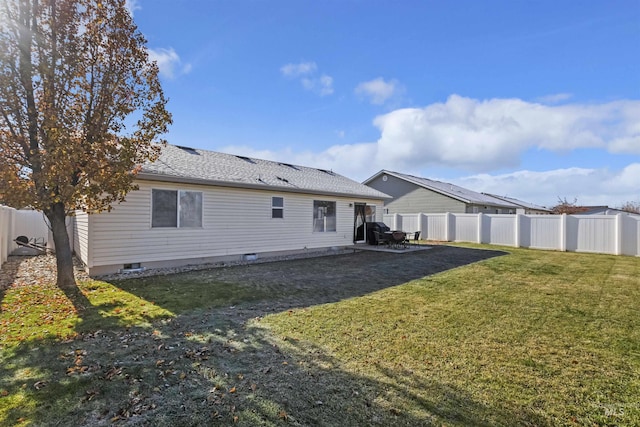 rear view of property featuring a yard and a patio area