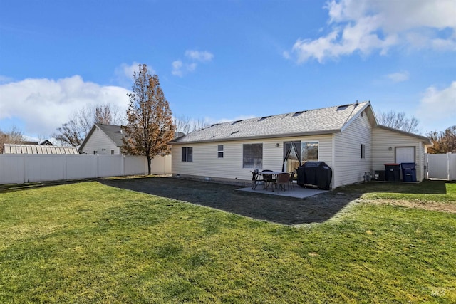 rear view of house featuring a patio and a yard