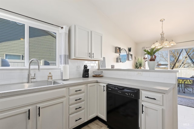 kitchen featuring lofted ceiling, sink, white cabinetry, black dishwasher, and decorative backsplash