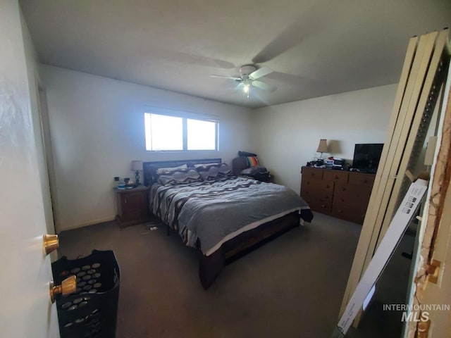 bedroom with ceiling fan and dark carpet