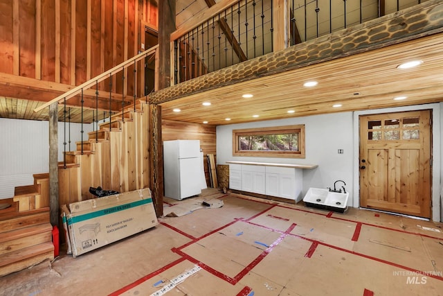5650 Pines Rd, New Meadows, ID 83654 - below grade area with freestanding refrigerator, stairway, and recessed lighting