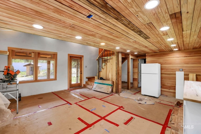 5650 Pines Rd, New Meadows, ID 83654 - basement with freestanding refrigerator, stairs, wooden ceiling, and recessed lighting