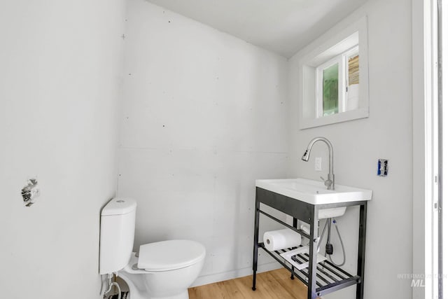 5650 Pines Rd, New Meadows, ID 83654 - half bath featuring wood finished floors and vanity