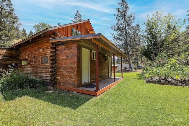5650 Pines Rd, New Meadows, ID 83654 - view of side of home with a lawn and log siding