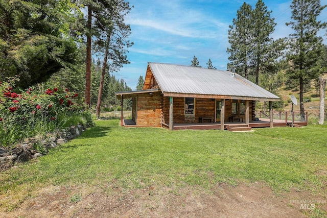 5650 Pines Rd, New Meadows, ID 83654 - back of house with covered porch, a lawn, a metal roof, and log exterior