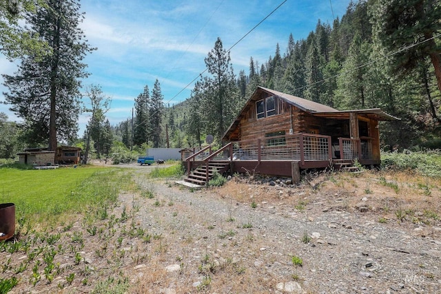 5650 Pines Rd, New Meadows, ID 83654 - view of home's exterior featuring a forest view and a deck