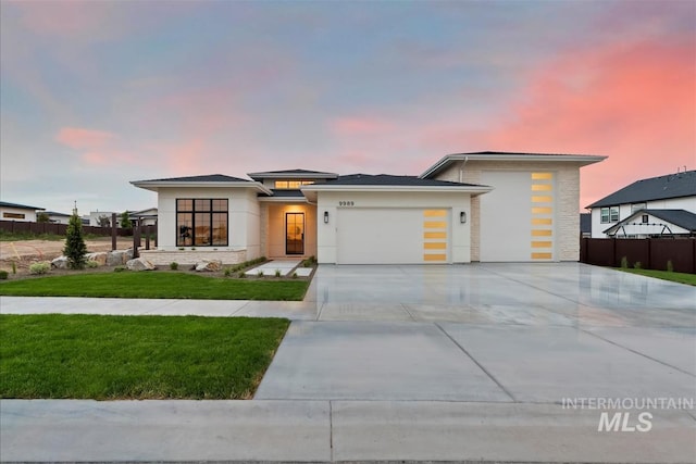 9989 W Bouvardia St, Star, ID 83699 - view of front facade featuring an attached garage, driveway, and stucco siding