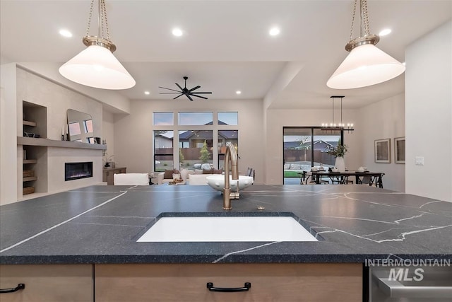 9989 W Bouvardia St, Star, ID 83699 - rec room with a sink, recessed lighting, a glass covered fireplace, and a ceiling fan