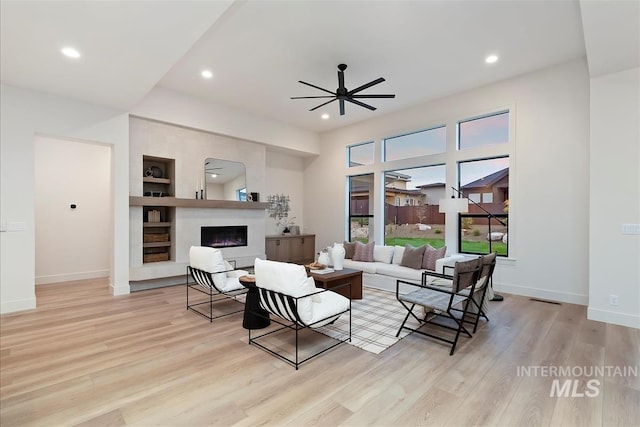9989 W Bouvardia St, Star, ID 83699 - living area with a warm lit fireplace, wood finished floors, recessed lighting, and baseboards
