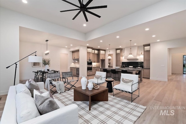 9989 W Bouvardia St, Star, ID 83699 - living room with light wood-type flooring, a ceiling fan, recessed lighting, and baseboards