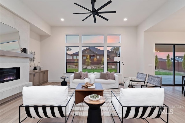 9989 W Bouvardia St, Star, ID 83699 - living room with a premium fireplace, light wood-style floors, ceiling fan, and recessed lighting