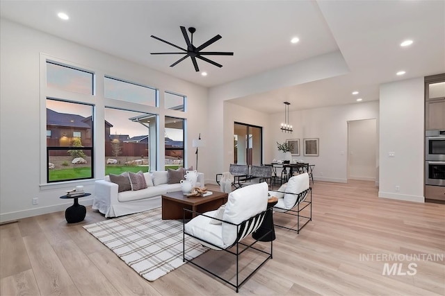 9989 W Bouvardia St, Star, ID 83699 - living room featuring light wood-style flooring, a chandelier, recessed lighting, and baseboards