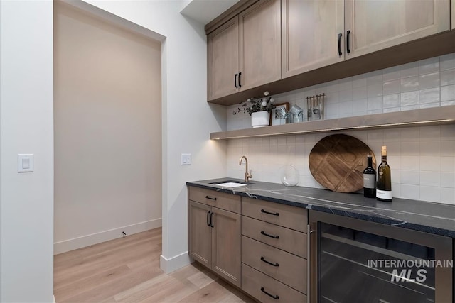 9989 W Bouvardia St, Star, ID 83699 - indoor wet bar featuring beverage cooler, light wood-style floors, backsplash, and baseboards