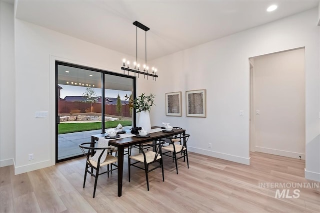 9989 W Bouvardia St, Star, ID 83699 - dining space featuring light wood-style floors, baseboards, recessed lighting, and a chandelier