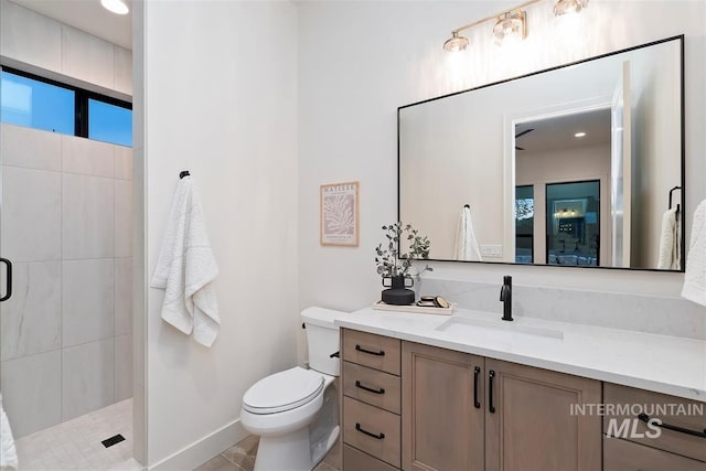 9989 W Bouvardia St, Star, ID 83699 - bathroom featuring a shower stall, vanity, toilet, baseboards, and tile patterned flooring