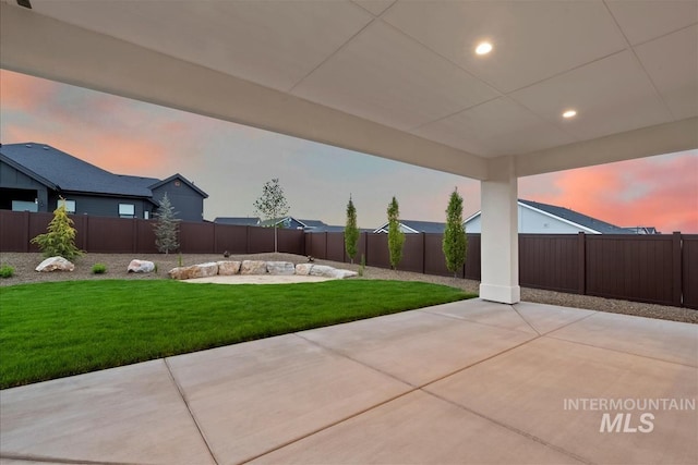 9989 W Bouvardia St, Star, ID 83699 - yard at dusk featuring a patio area