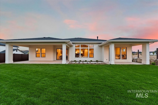 9989 W Bouvardia St, Star, ID 83699 - back of house at dusk featuring a patio and stucco siding