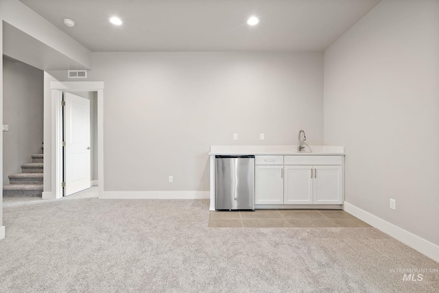 kitchen featuring light carpet, visible vents, recessed lighting, and refrigerator