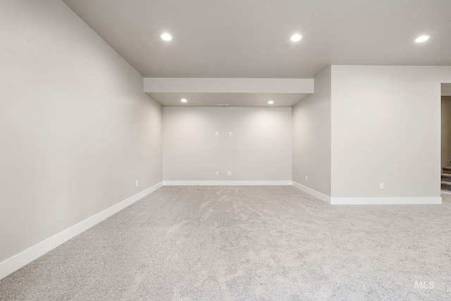 finished basement featuring light colored carpet, recessed lighting, and baseboards