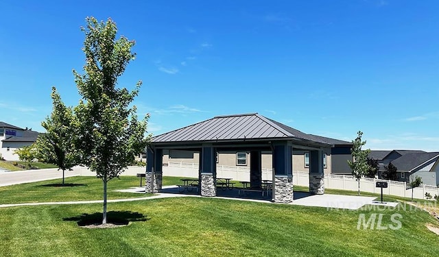 view of community with a gazebo, a yard, and fence