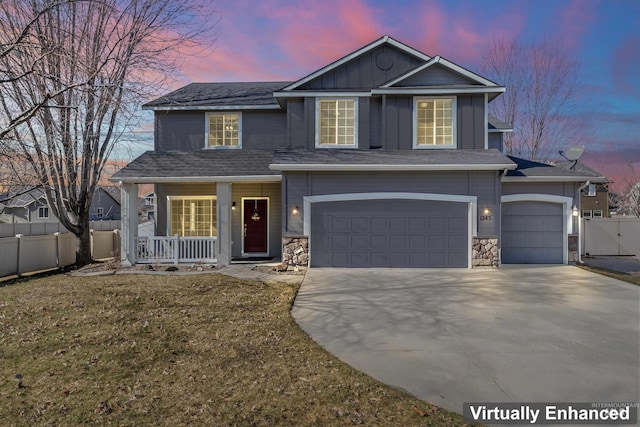 traditional home with a garage, concrete driveway, fence, a porch, and board and batten siding