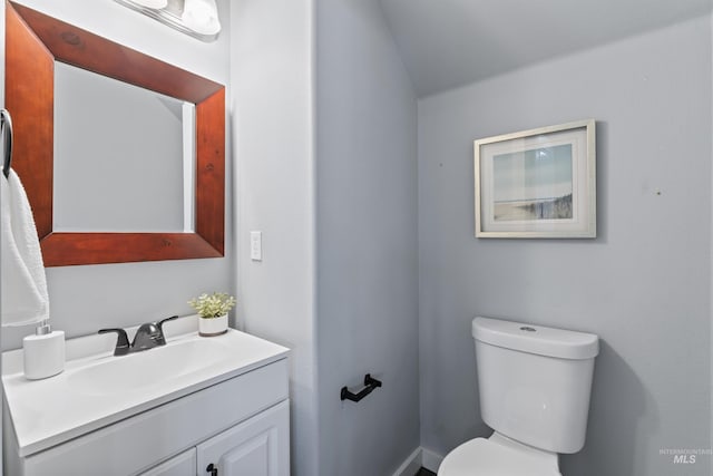 bathroom featuring toilet and vanity