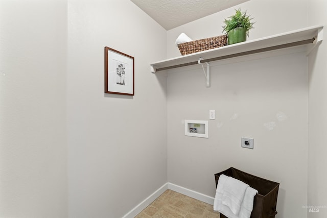 laundry room featuring hookup for a washing machine, electric dryer hookup, a textured ceiling, laundry area, and baseboards