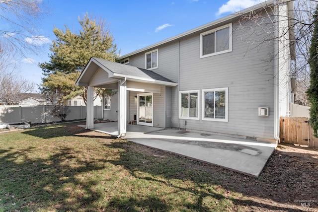 back of house featuring a lawn, a patio area, and fence