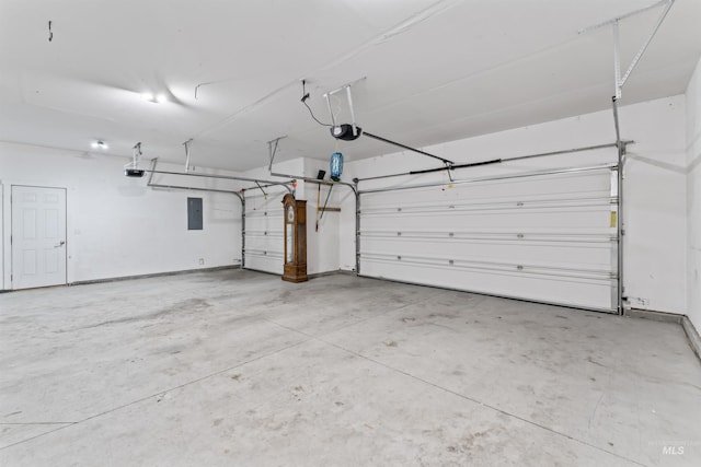 garage with electric panel and a garage door opener