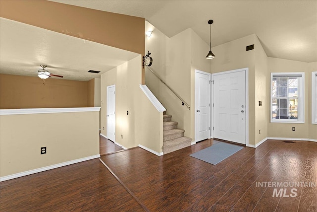 entryway with ceiling fan, dark hardwood / wood-style floors, and lofted ceiling