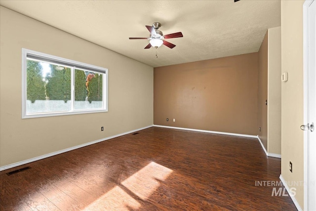 spare room featuring ceiling fan and dark hardwood / wood-style floors