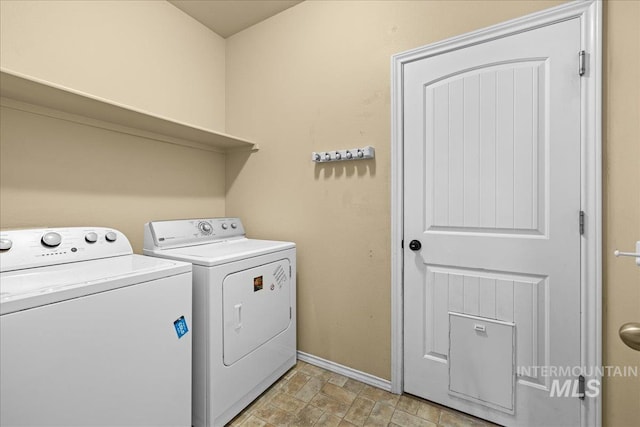 clothes washing area featuring separate washer and dryer