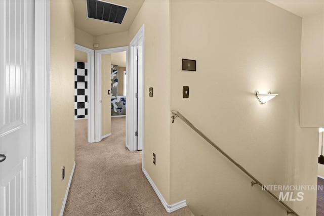 hall featuring light colored carpet