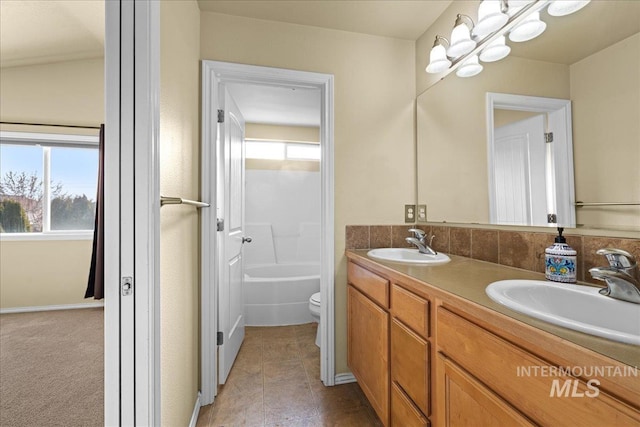 full bathroom featuring shower / bathing tub combination, plenty of natural light, toilet, and vanity