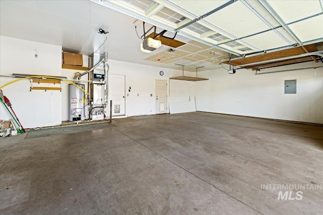 garage with gas water heater, electric panel, and a garage door opener